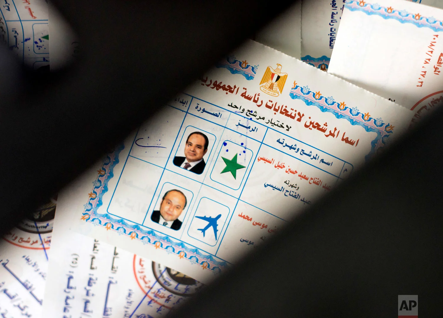 Ballots with photos and names of presidential candidates Abdel-Fattah el-Sissi, at top, and Moussa Mustafa Moussa, are visible inside a ballot box at a polling station, during the first day of the presidential election, in Cairo, Egypt, Monday, March 26, 2018. Egyptians head to the polls on Monday but the presidential election this time is not about who wins — that was settled long ago — but about how many people bother to cast ballots. (AP Photo/Amr Nabil)