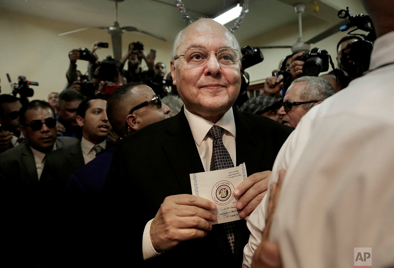 Egyptian presidential candidate Moussa Mustafa Moussa holds a ballot before casting his vote during the first day of the presidential election, at a polling station, in Cairo, Egypt, Monday, March 26, 2018. Polls opened on Monday in Egypt's presidential election with the outcome — a second, four-year term for President Abdel-Fattah el-Sissi — a foregone conclusion, in what is seen by critics as a signal of the country's return to the authoritarian rule that prevailed since the 1950s. (AP Photo/Nariman El-Mofty)