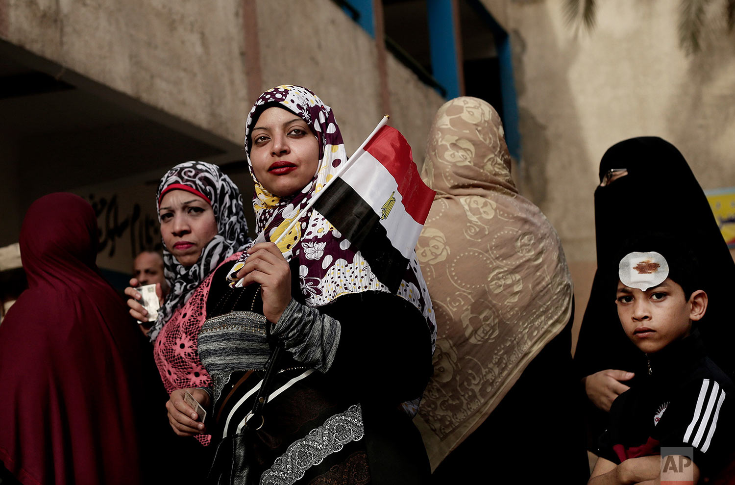 Women wait in line to vote outside a polling station at a school in the Omraniyah district of Giza, Egypt Tuesday, March 27, 2018. Turnout appeared low as Egyptians voted on the second day of an election that President Abdel-Fattah el-Sissi is virtually certain to win, after all serious rivals were either arrested or intimidated into dropping out. (AP Photo/Nariman El-Mofty)