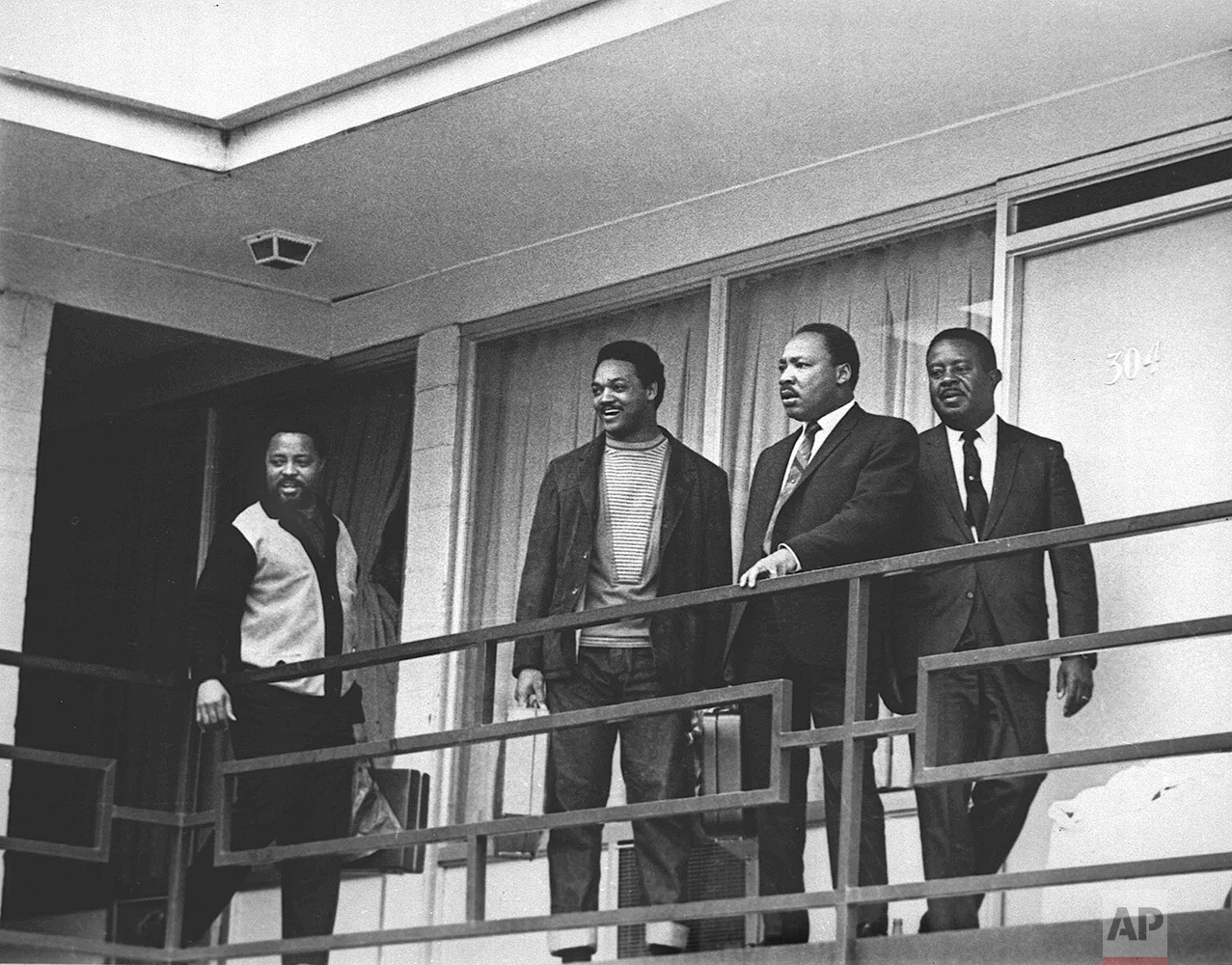 The Rev. Martin Luther King Jr. stands with other civil rights leaders on the balcony of the Lorraine Motel in Memphis, Tenn., on April 3, 1968, a day before he was assassinated at approximately the same place. From left are Hosea Williams, Jesse Jackson, King, and Ralph Abernathy. (AP Photo/Charles Kelly)