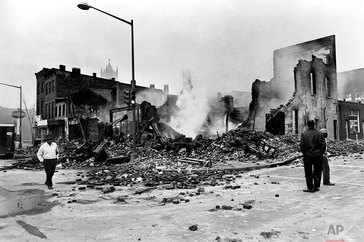 Smoldering ruins remain where a building stood on 7th Street, N.W. in Washington, D.C., April 6, 1968. Numerous fires accompanied the second night of turmoil in the nation's capital following the assassination of Dr. Martin Luther King, Jr., in Memphis, Tenn., April 4. (AP Photo)