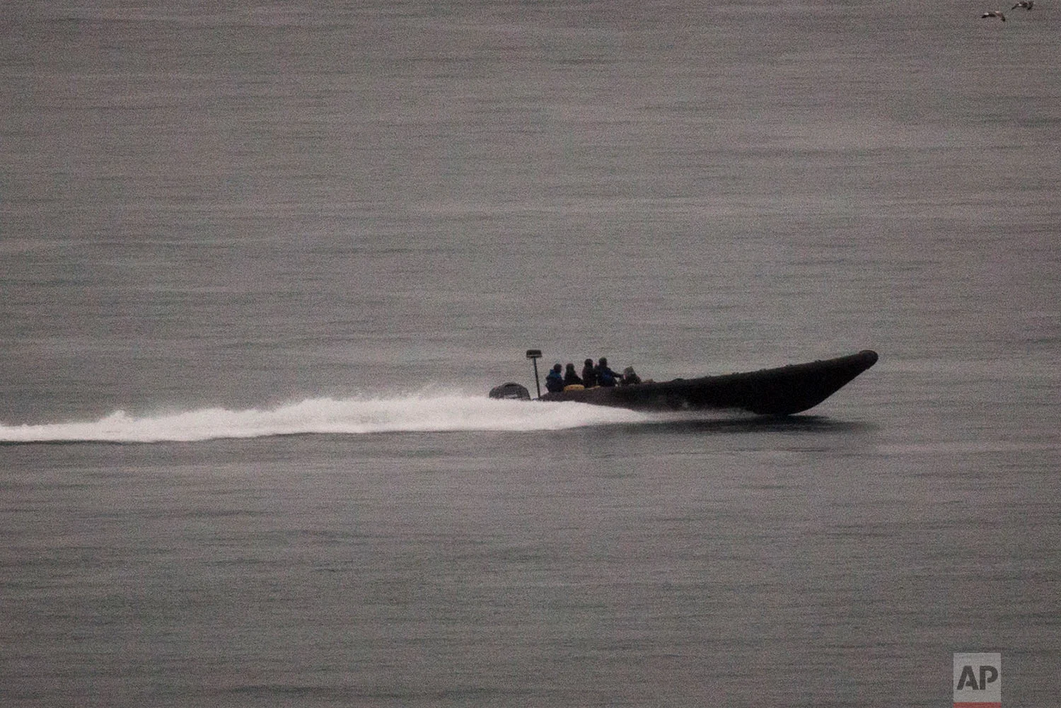 A speedboat with boxes of alleged drug cargo onboard sails along the coast of La Linea de la Conception, in Cadiz province, south of Spain. (AP Photo/Emilio Morenatti)