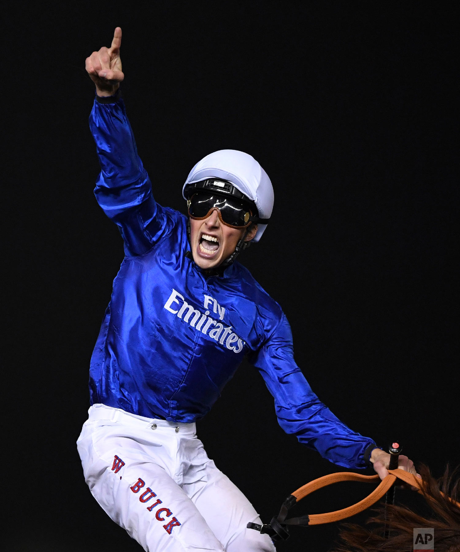 Jockey William Buick celebrates on Godolphin's Hawkbill victory in the $6 million Group 1 Dubai Sheema Classic over 2410m in Dubai, the United Arab Emirates, Saturday, March 31, 2018. (AP Photo/Martin Dokoupil)