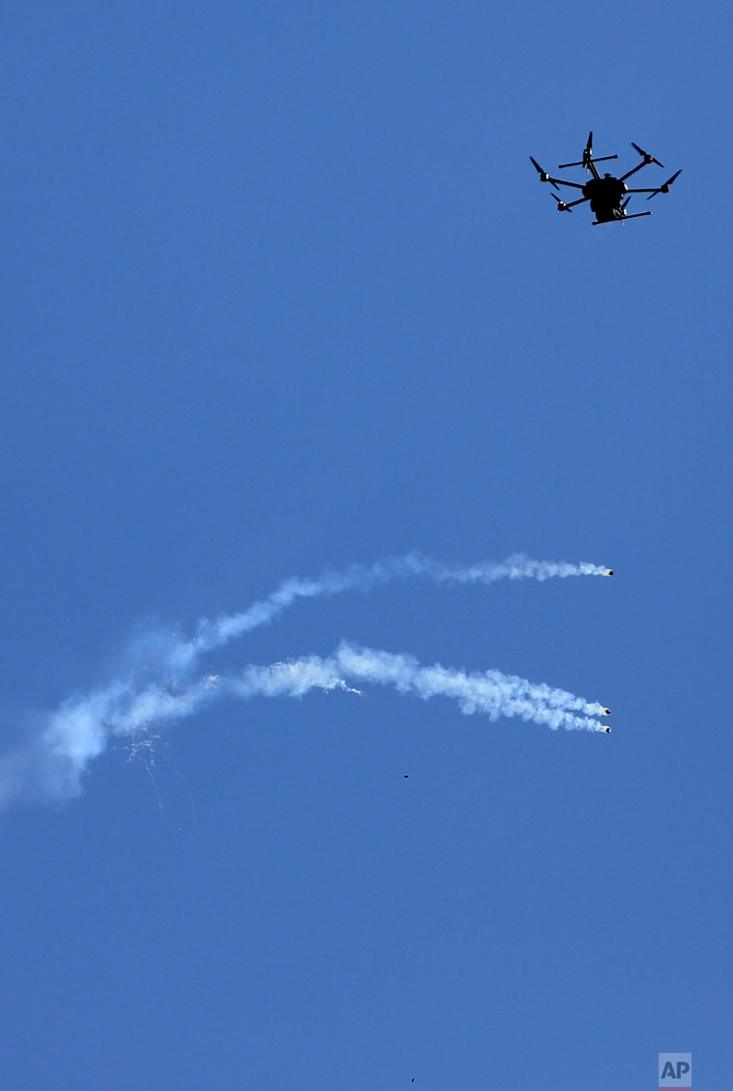  A drone used by Israeli troops fires teargas at Palestinians during a demonstration near the Gaza Strip border with Israel, in eastern Gaza City, Friday, March 30, 2018. (AP Photo/ Khalil Hamra) 