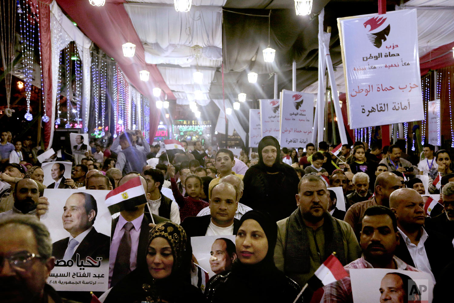  Supporters of Egyptian presidential candidate President Abdel-Fattah el-Sissi hold campaign posters during a campaign rally, near the Gamaleya district of Cairo, where el-Sissi was born, in front of al-Hussein Mosque, Egypt, Monday, March 19, 2018. 