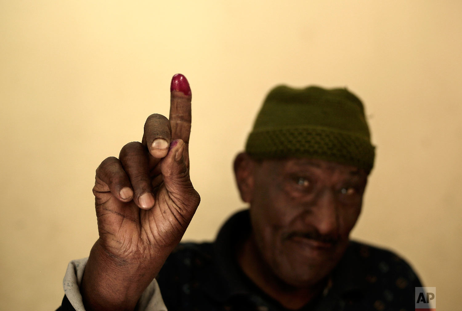 A man shows his inked finger after voting during the first day of the presidential election inside a polling station in Cairo, Egypt, Monday, March 26, 2018. (AP Photo/Nariman El-Mofty)