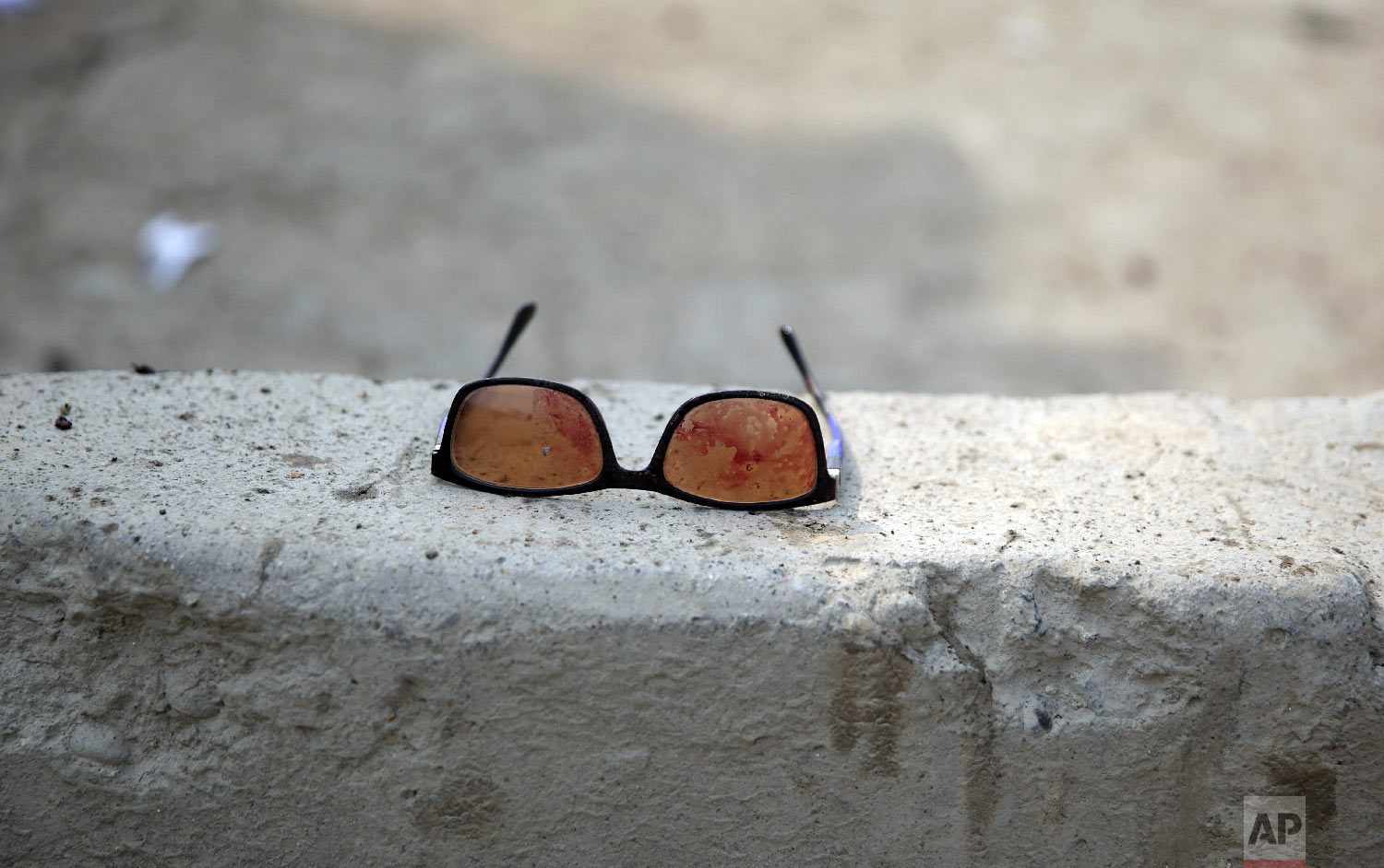 Sunglasses covered in blood are left at the site of a suicide attack in Kabul, Friday, March 9, 2018.(AP Photo/Massoud Hossaini)