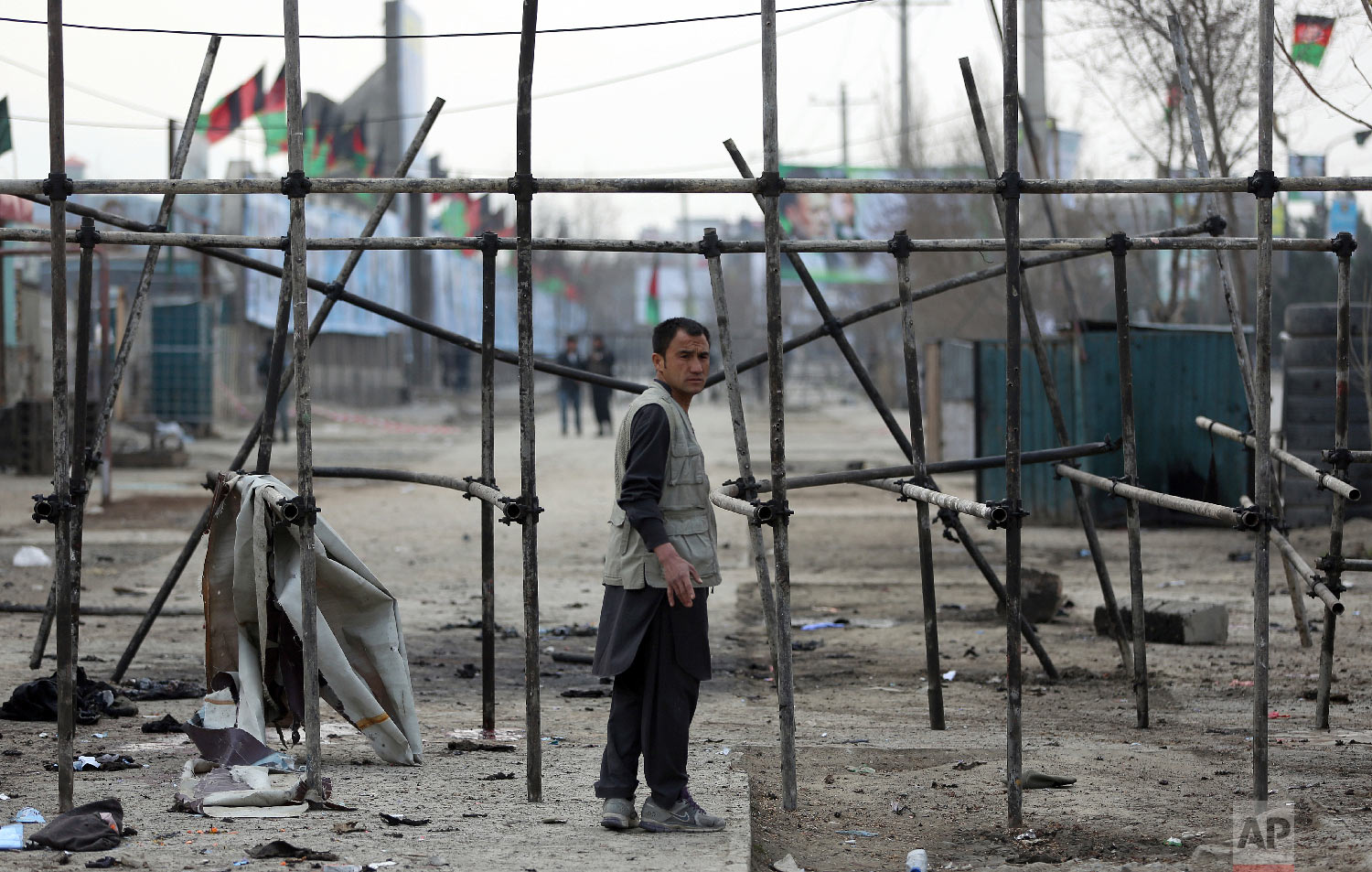 A man stands at site of a suicide attack in Kabul, Friday, March 9, 2018. (AP Photo/Massoud Hossaini)