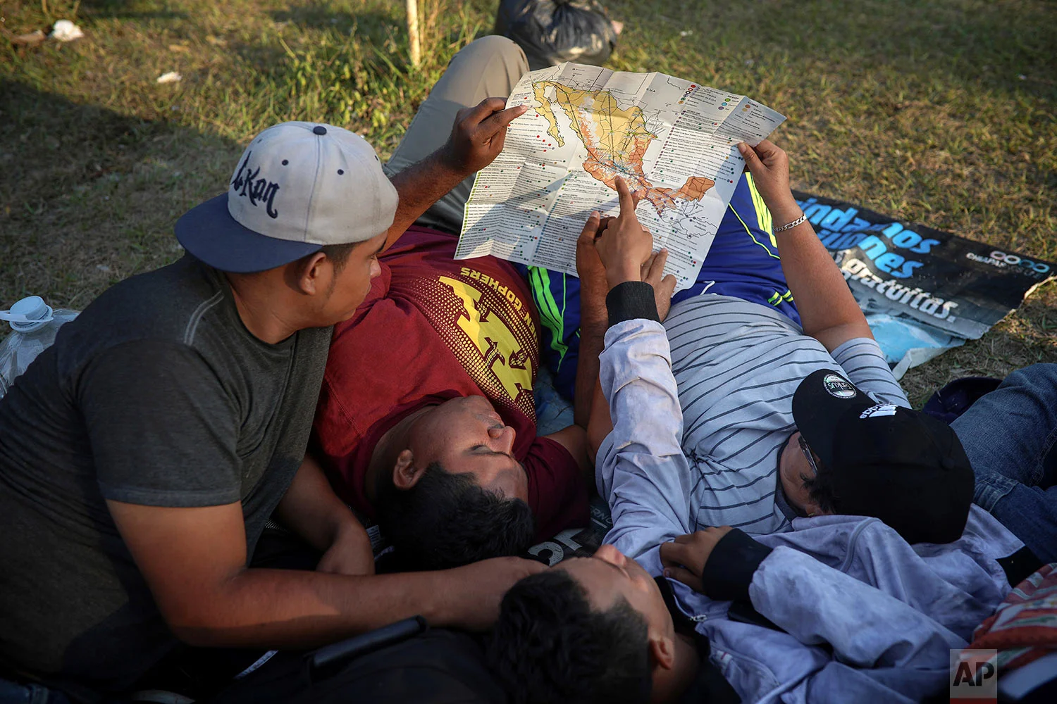 Men study a map of Mexico in Matias Romero, Oaxaca State, Mexico, Wednesday, April 4, 2018. (AP Photo/Felix Marquez)