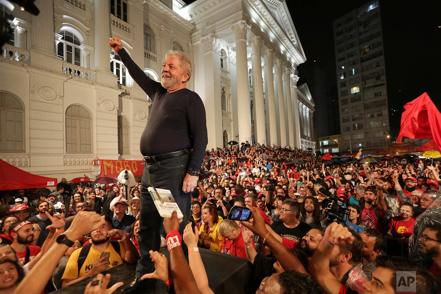 Brazil's former President Luiz Inacio Lula da Silva stands amid supporters during the final rally of his week-long campaign tour of southern Brazil, in Curitiba, Parana state, Brazil, March 28, 2018. Da Silva defended his record and denounced protests against him as the work of fascists, a day after an attack on his campaign caravan exposed the deep divisions ahead of heated elections. (AP Photo/Eraldo Peres)