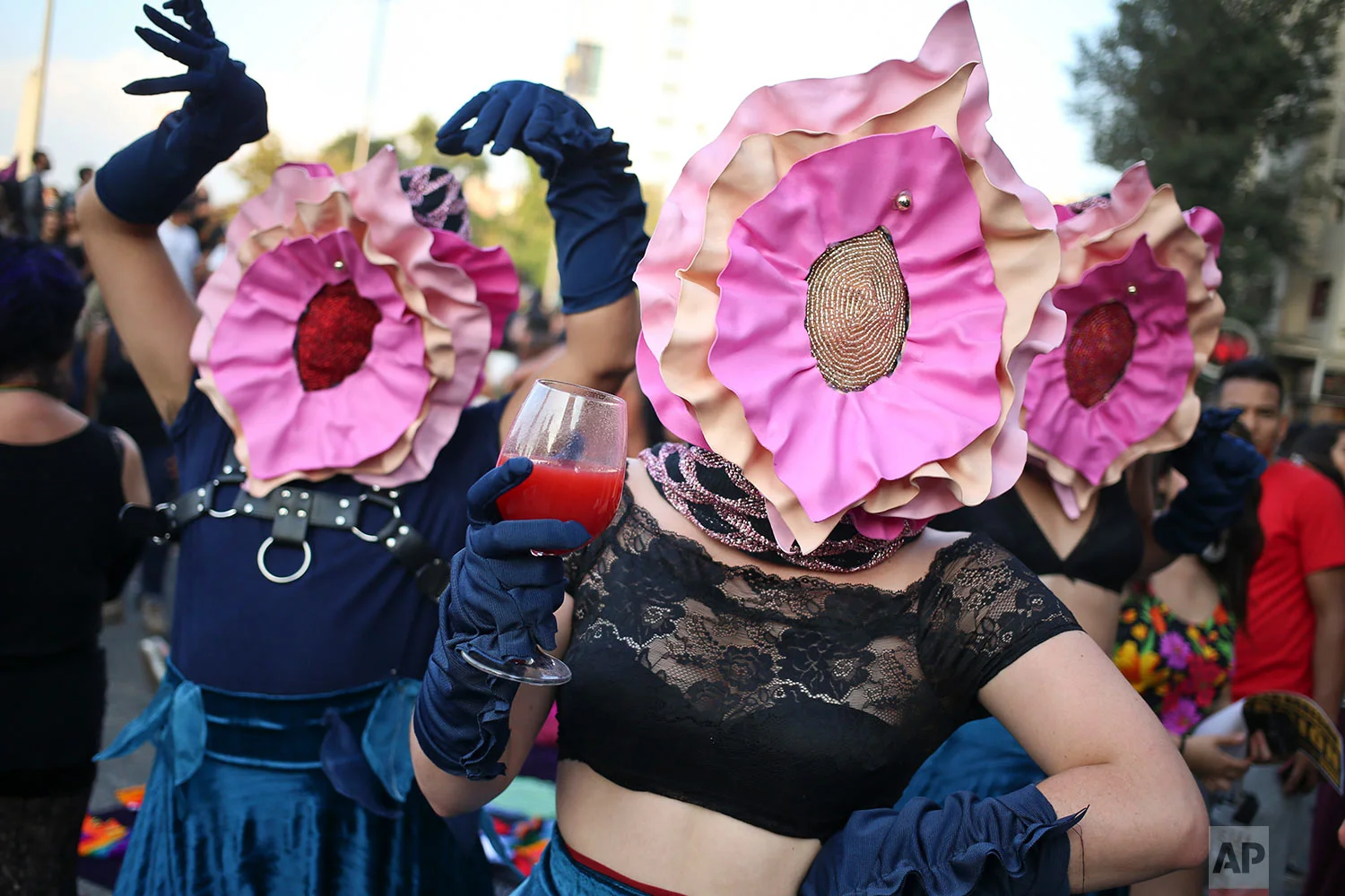 Women wearing masks in the likeness of vaginas perform during a march commemorating International Women's Day in Santiago, Chile, March 8, 2018. Many women stayed home from work, joined rallies or wore red Wednesday as International Women's Day was observed with a multitude of events around the world. (AP Photo/Esteban Felix)