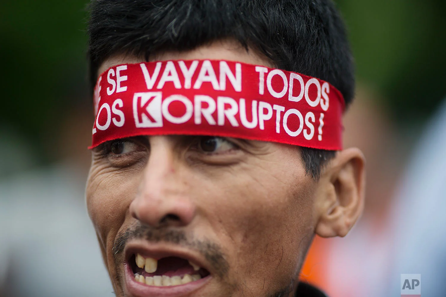 A man wears a bandana with text that reads in Spanish "Let all the corrupt go," during a protest against the country's political class, a day after the resignation of Peru's President Pedro Pablo Kuczynski, in Lima, Peru, March 22, 2018. Peru's congress is gearing up to consider whether or not to accept Kuczynski's resignation following the release of several videos appearing to show allies offering state contracts in exchange for votes against his pending impeachment. (AP Photo/Rodrigo Abd)