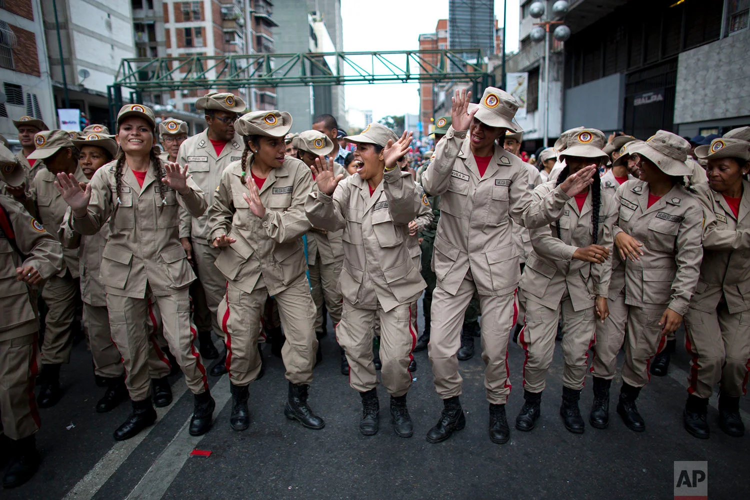 Female members of the Bolivarian Militia dance during an event marking the fifth anniversary of death of Venezuela's late President Hugo Chavez in Caracas, Venezuela, March 5, 2018. Officially known as the Venezuelan National Bolivarian Militia, it is a branch of the National Armed Forces of Venezuela created by Chavez. (AP Photo/Ariana Cubillos)