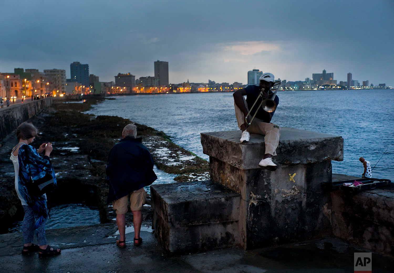 In this April 13, 2018 photo, musician Lazaro Martinez poses with his trombone on the Malecon sea wall in Havana, Cuba. Since 1991, Martinez has regularly played his music at the Malecon. “My politics are music,” said the 52-year-old. (AP Photo/Ramon Espinosa)
