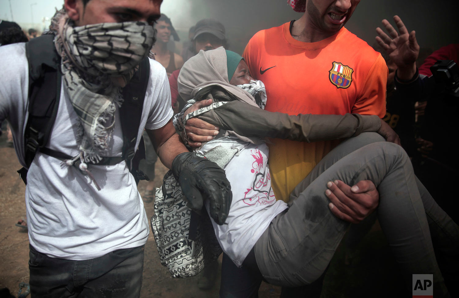  Palestinian protesters evacuate a wounded woman during a protest at the Gaza Strip's border with Israel, Friday, April 20, 2018. Thousands of Palestinians joined the fourth weekly protest on Gaza's border with Israel on Fridays. Hamas says the prote