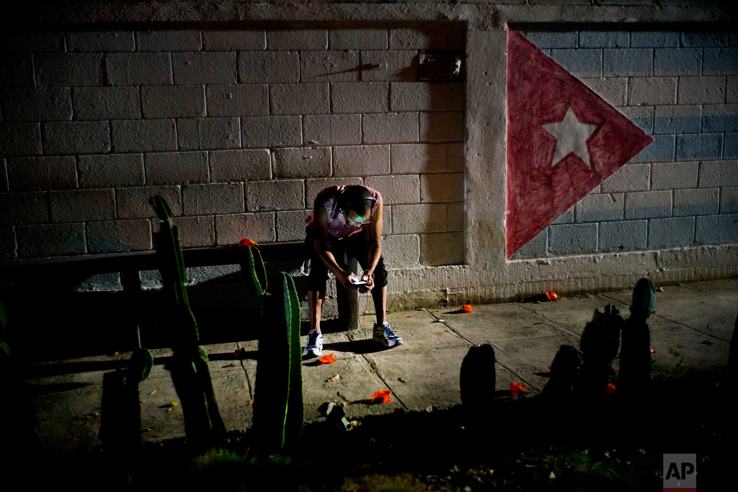  Lazaro Rodriguez, 42, connects his cellphone at a public internet hot spot at night in Havana, Cuba on Saturday, April 14, 2018. Lazaro, who studied baking and is currently working in maintenance, said he's seen very positive changes in the economy 