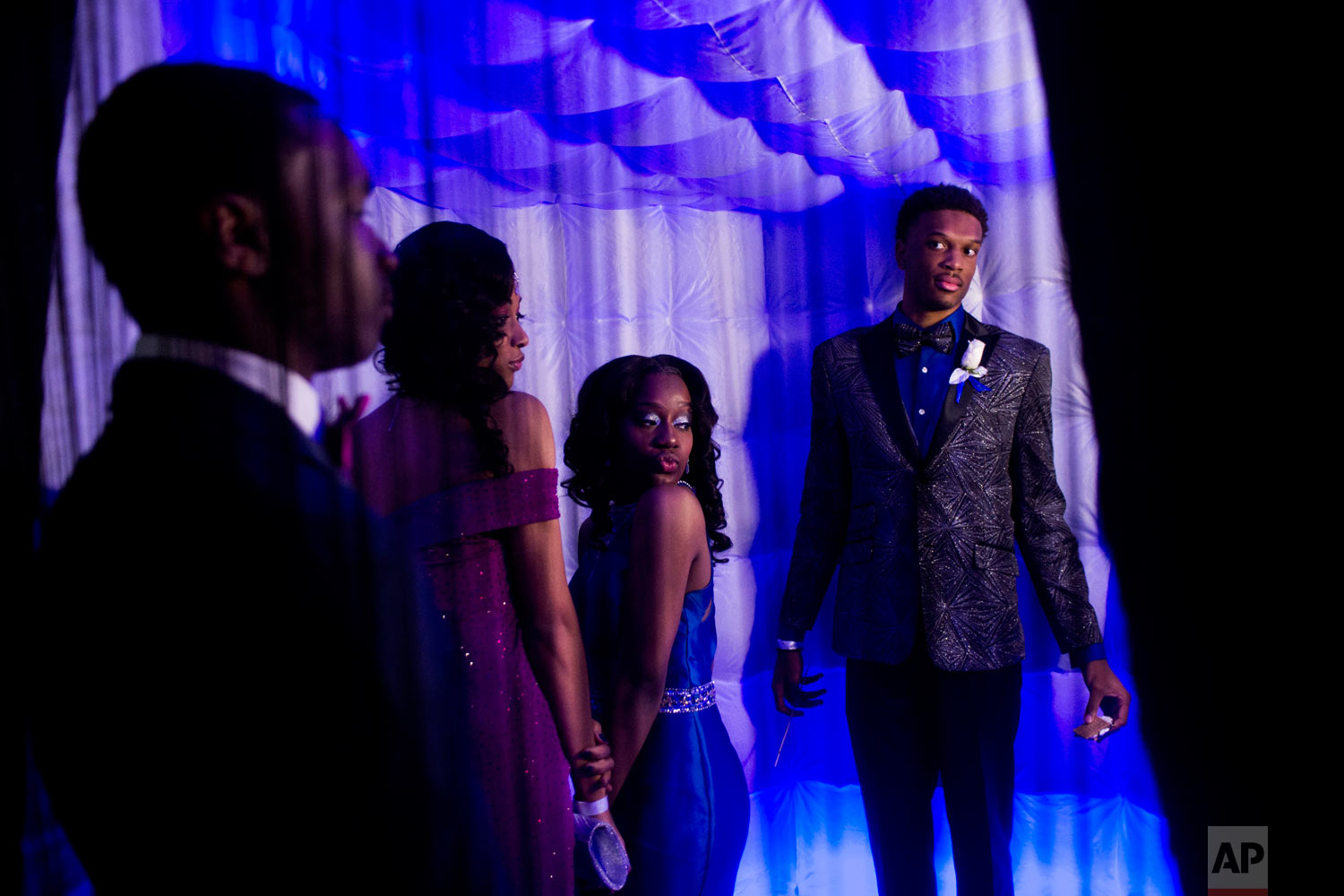  Swartz Creek seniors Yasminae Holmes, second from left, and Jada Hall pose for a photo booth camera as their dates Anthony Roberts, left, a Swartz Creek senior, and Chris Long, a Beecher senior, watch while attending the Swartz Creek High School pro