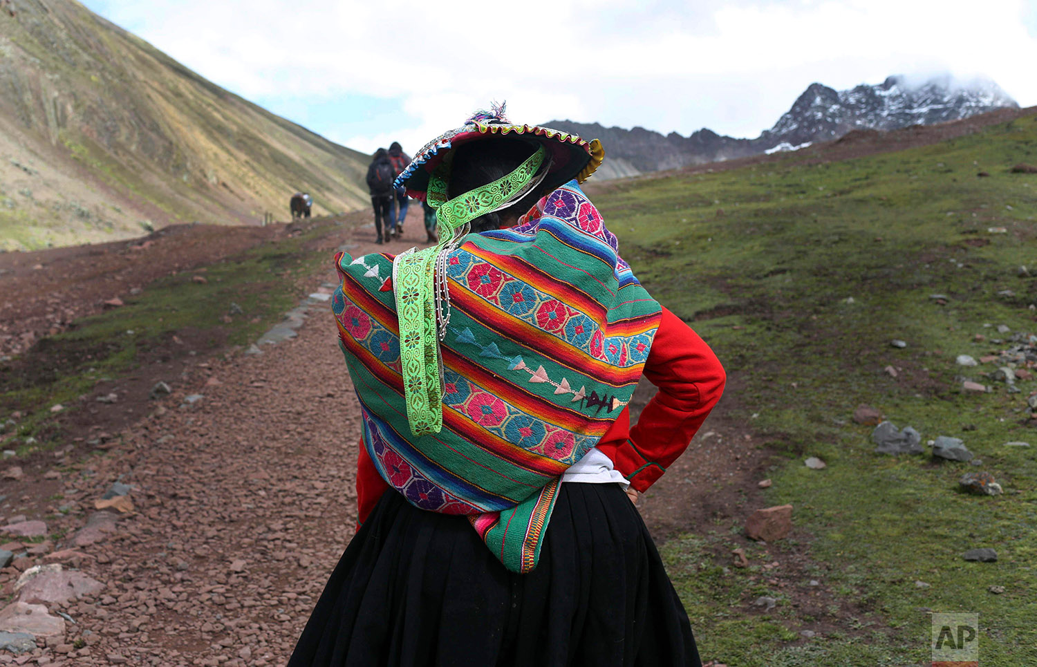  In this March 2, 2018 photo, an Andean woman walks to Rainbow Mountain in Pitumarca, Peru. (AP Photo/Martin Mejia) 