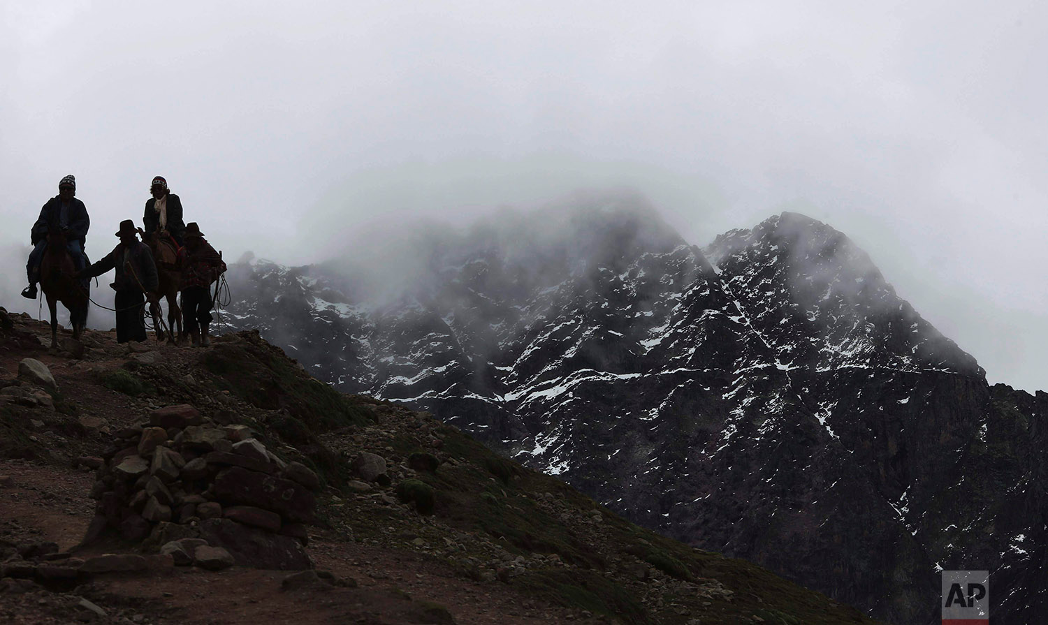  In this March 2, 2018 photo, a group of tourists ride horses led by Andean guides to Rainbow Mountain, in Pitumarca, Peru. (AP Photo/Martin Mejia) 