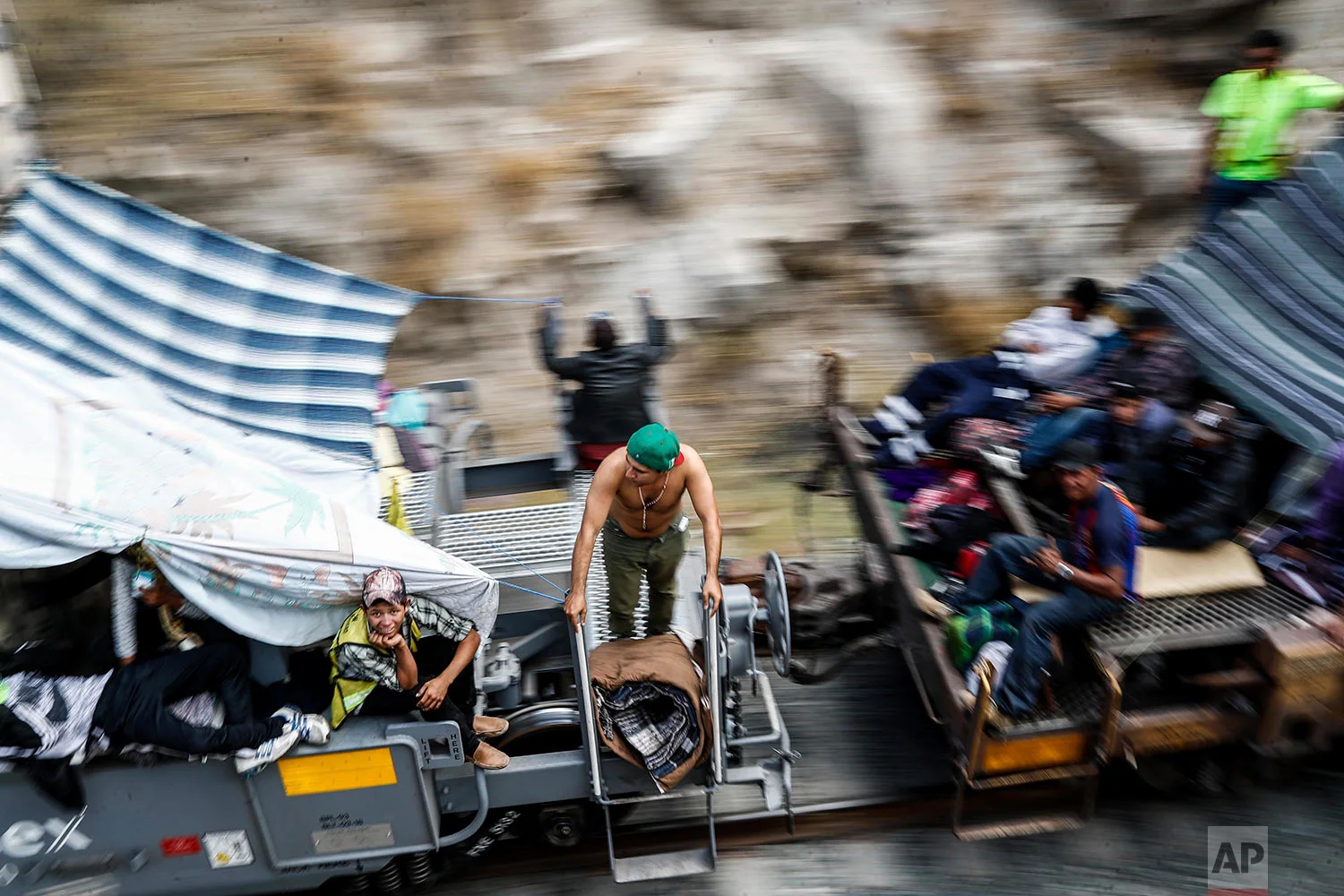 Central American migrants, who attended the annual Migrants Stations of the Cross caravan for migrants' rights, ride a northern-bound train known as "La Bestia," or The Beast, as they arrive to Hermosillo, Sonora state, Mexico, Saturday, April 21, 2018. The remnants of the migrant caravan that drew the ire of President Donald Trump were continuing their journey north through Mexico toward the U.S. border. (AP Photo/Luis Gutierrez)