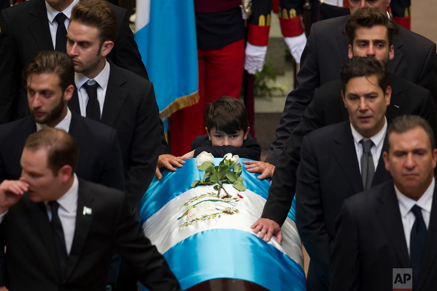 The coffin with the remains of former President and current mayor of Guatemala City Alvaro Arzu is escorted by relatives during a farewell ceremony at the National Palace in Guatemala City, Saturday, April 28, 2018. Arzu, 72, who signed peace in Guatemala in 1996 died of a heart attack on Friday. (AP Photo/Moises Castillo)