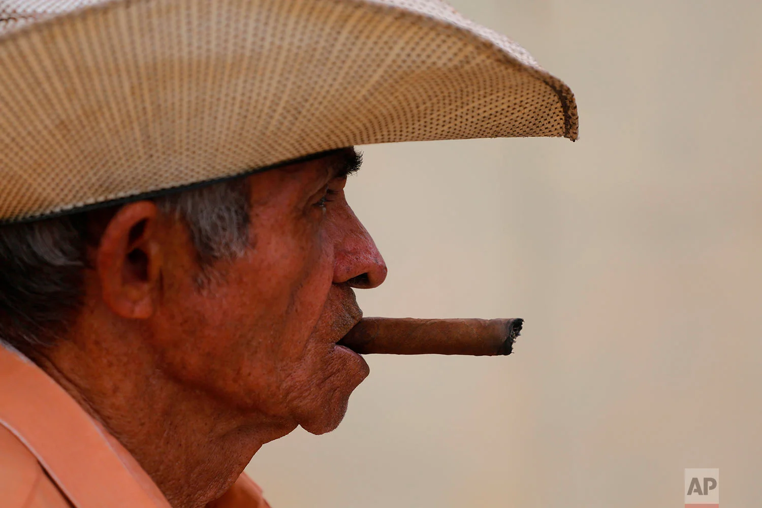 Edelio Jimenez Santana, 81, smokes a cigar in the Vigia neighborhood of Santa Clara, Cuba, where he was a neighbor of Miguel Mario Diaz-Canel Bermudez, the he man who is expected to be Cuba's next president, April 1, 2018. Diaz-Canel was born and raised in Santa Clara where he spent nine years in a role akin to a governor. (AP Photo/Desmond Boylan)