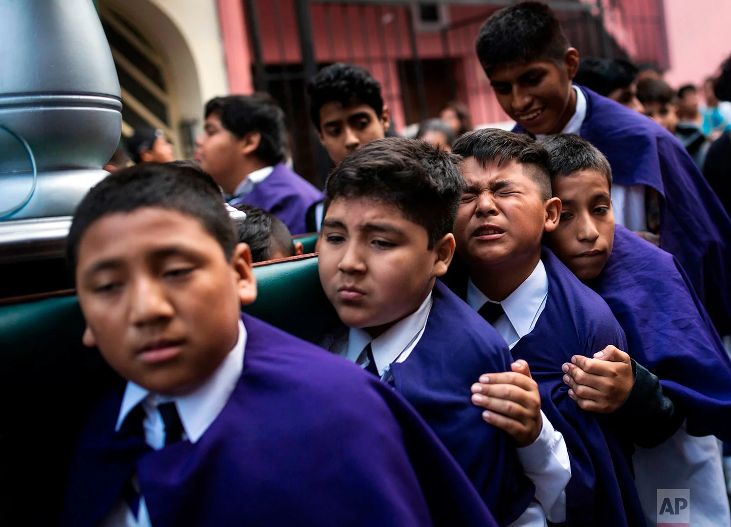 Children carry an image of Jesus Christ while taking part in a Holy Week procession in Lima, Peru, April 1, 2018. Processions take place throughout Peru during the Easter Holy Week. (AP Photo/Rodrigo Abd)