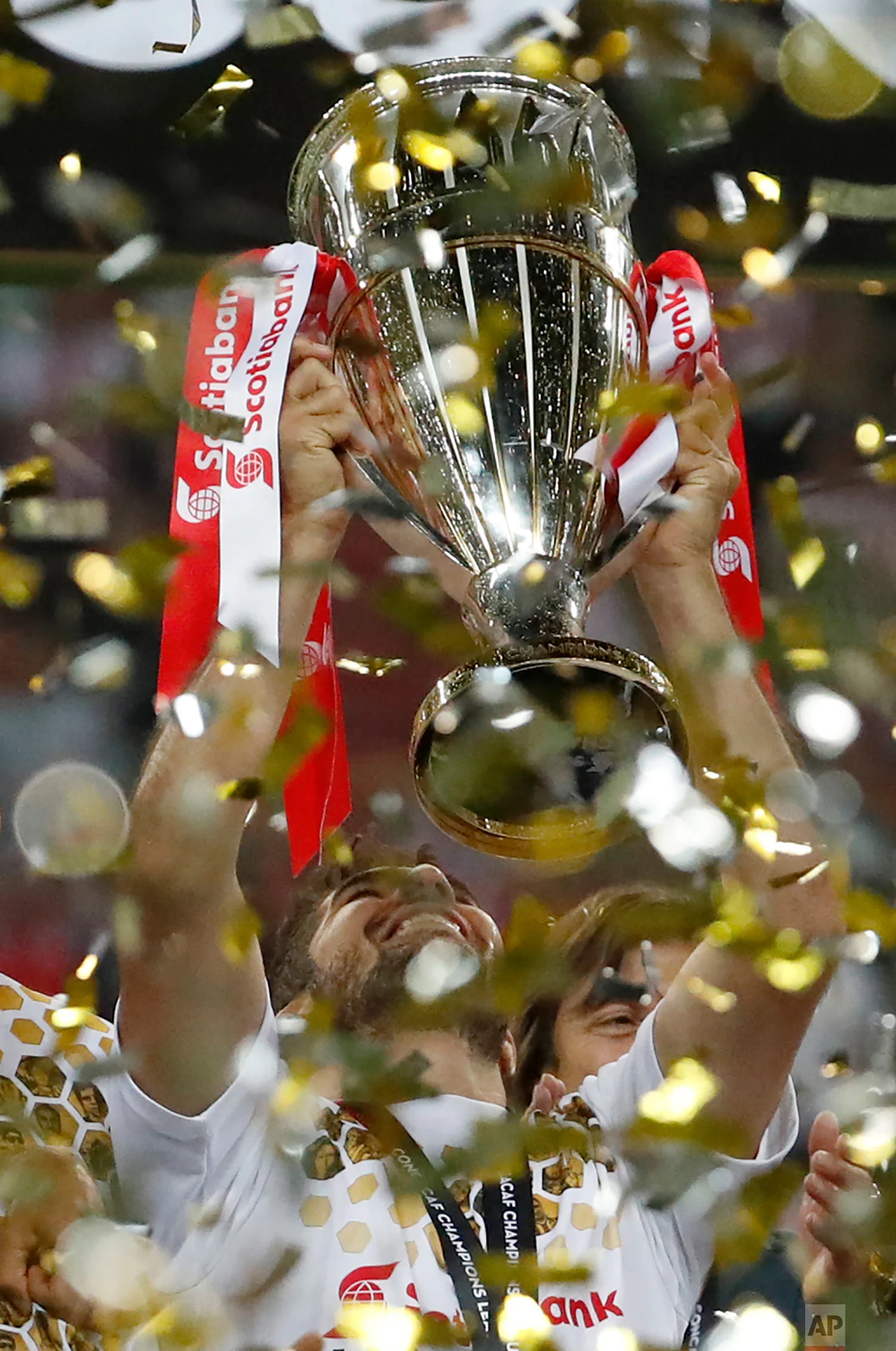 Chivas' Jair Pereira holds the trophy aloft as he celebrates his team's victory over Toronto FC in the CONCACAF Champions League final soccer match, in Guadalajara, Mexico, Wednesday, April 25, 2018. Chivas defeated Toronto FC in a penalty shoot out. (AP Photo/Eduardo Verdugo)