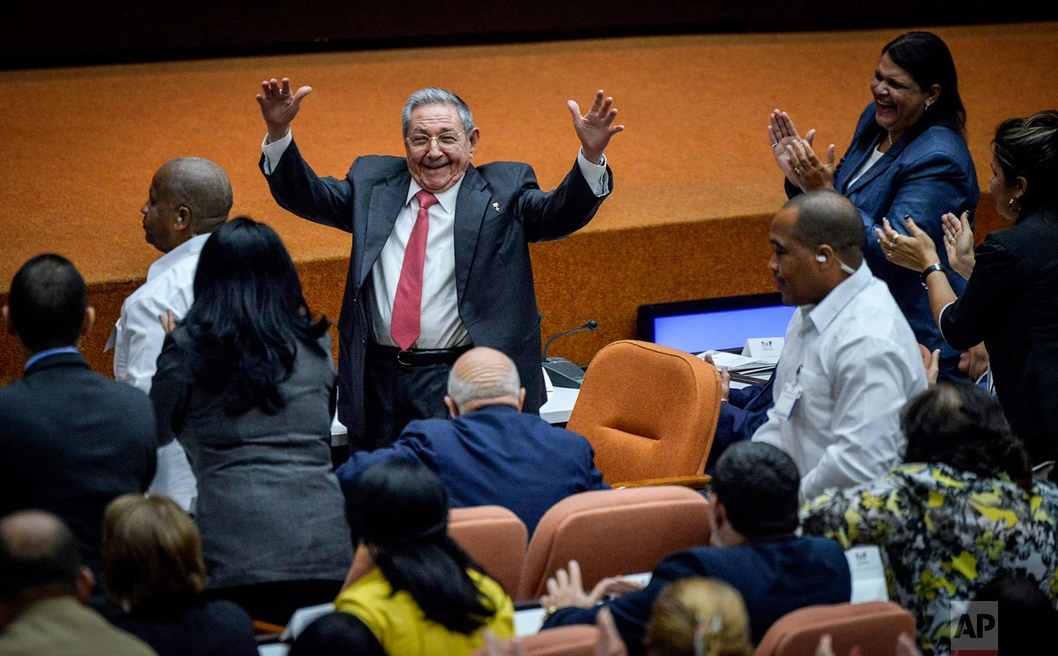 Outgoing President Raul Castro raises his arms in celebration after Miguel Diaz-Canel was elected as the island nation's new president, at the National Assembly in Havana, Cuba, Thursday, April 19, 2018. Castro passed Cuba's presidency to Diaz-Canel, putting the island's government in the hands of someone outside the Castro family for the first time in nearly six decades. He remains head of the powerful Communist Party that oversees political and social activities. (Adalberto Roque/Pool via AP)