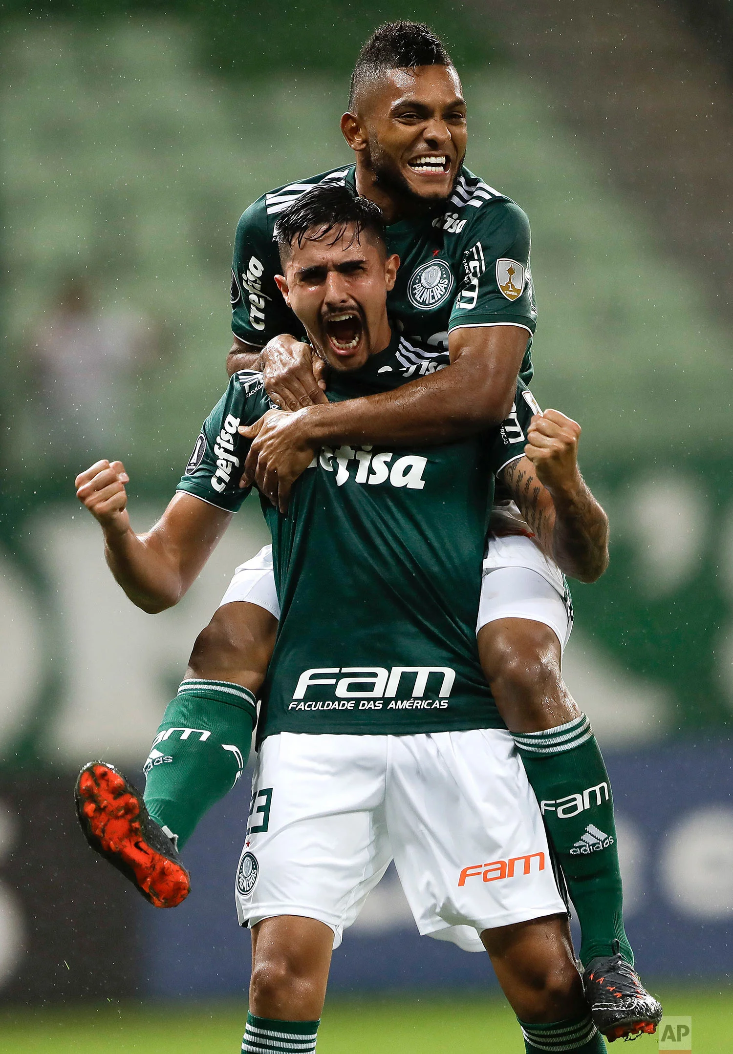 Thiago Martins of Brazil's Palmeiras, front, celebrates with teammate Miguel Borja after scoring against Peru's Alianza Lima at a Copa Libertadores soccer match in Sao Paulo, Brazil, Tuesday, April 3, 2018. (AP Photo/Andre Penner)