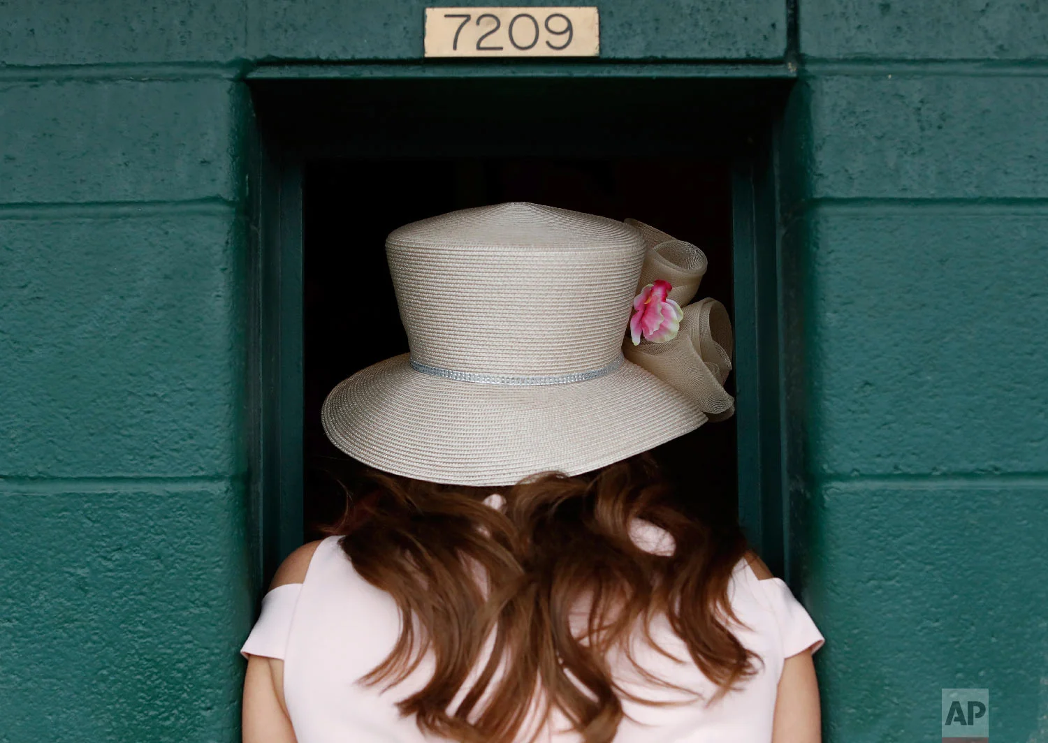 A women places a bet before the 144th running of the Kentucky Oaks horse race at Churchill Downs Friday, May 4, 2018, in Louisville, Ky. (AP Photo/John Minchillo)