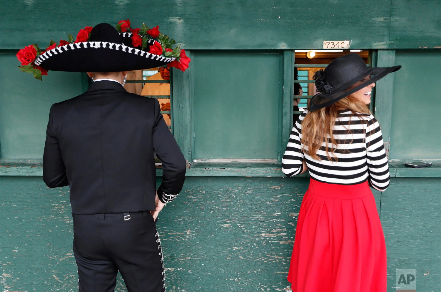 Fans place bets before the 144th running of the Kentucky Derby horse race at Churchill Downs Saturday, May 5, 2018, in Louisville, Ky. (AP Photo/John Minchillo)