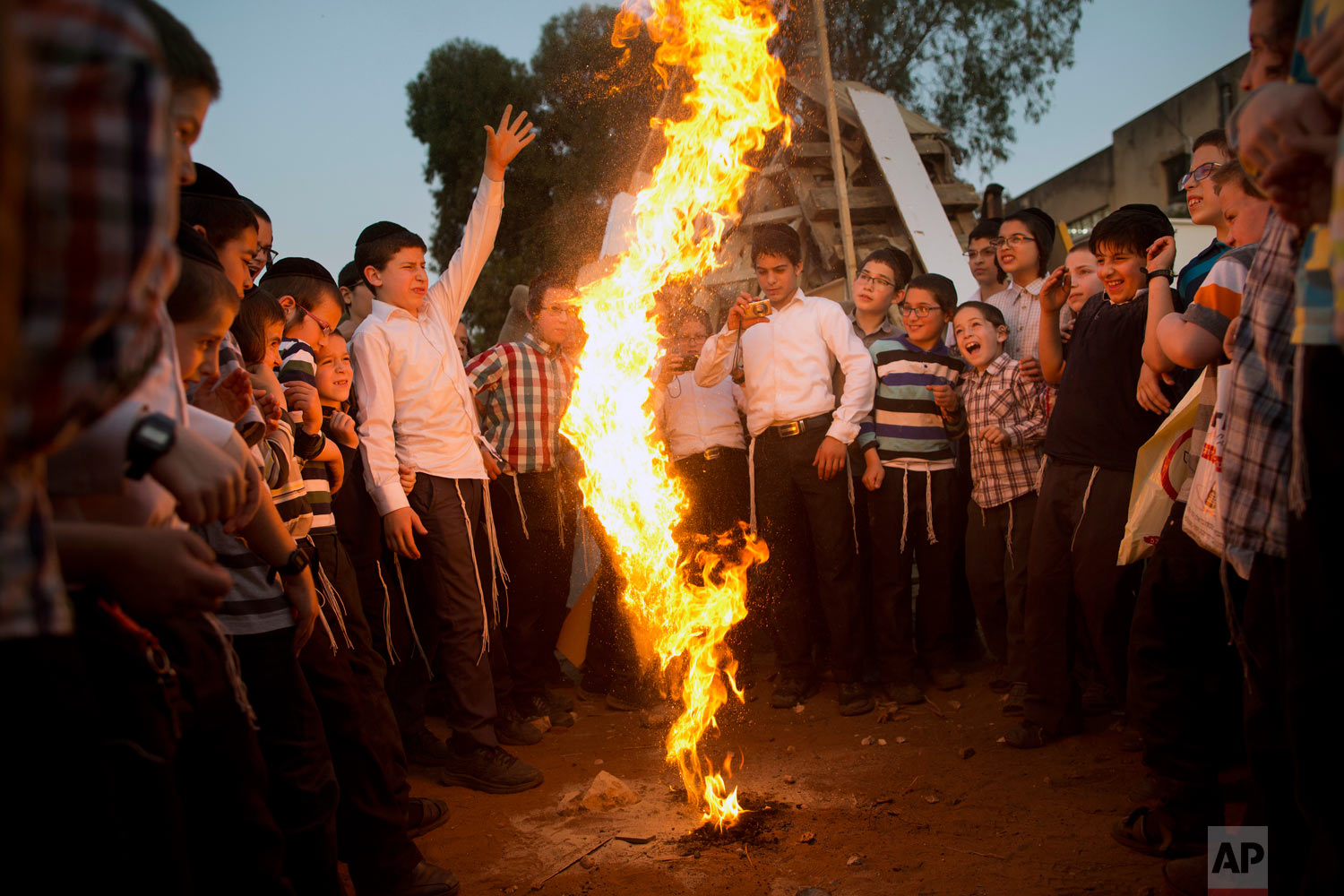 Ultra-Orthodox Jewish youths play with fire during the Jewish holiday of Lag Ba'Omer in Bnei Brak, Israel, Wednesday, May 2, 2018. The holiday marks the end of a plague said to have decimated Jews during the Roman times. (AP Photo/Oded Balilty)