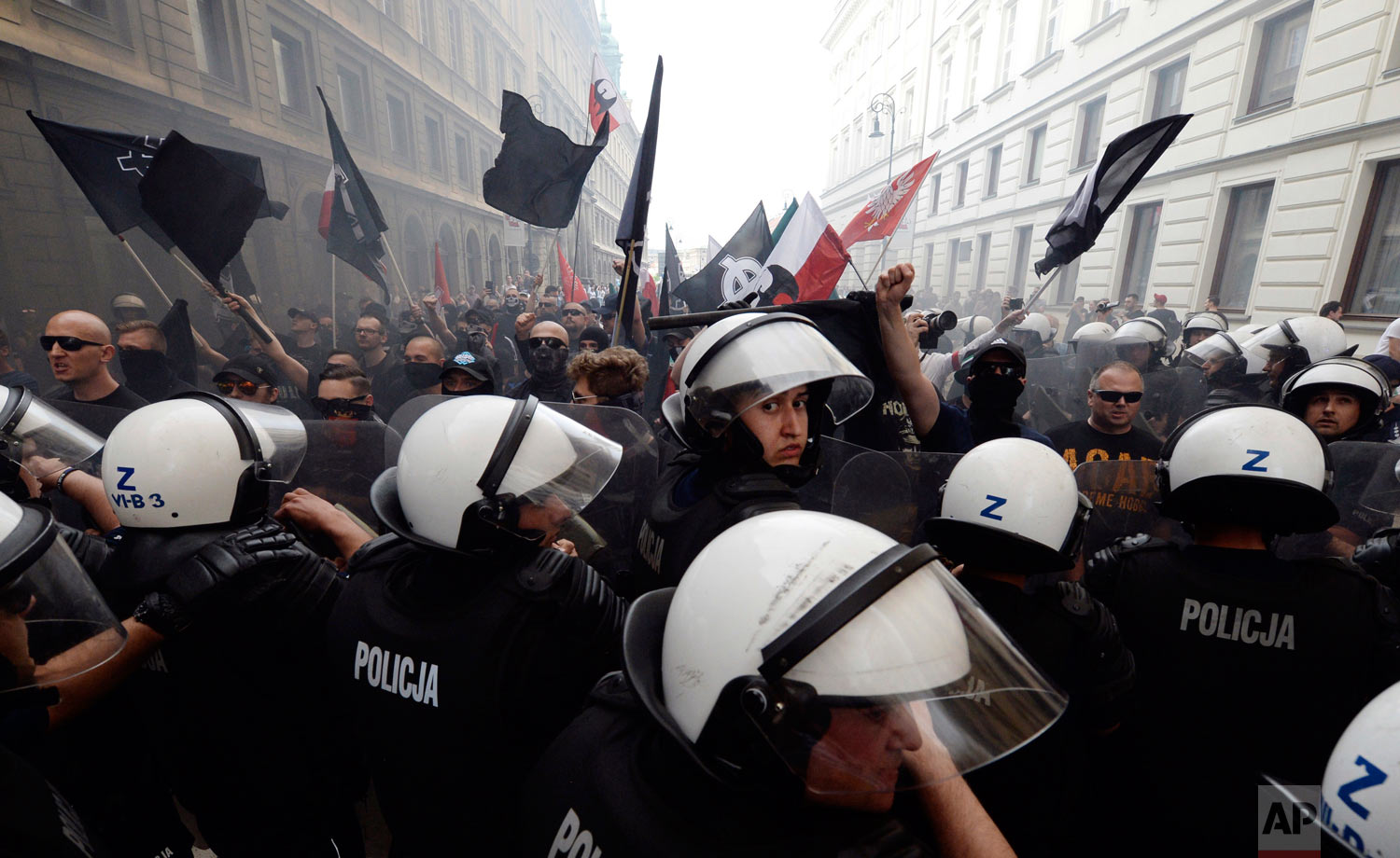 Police clash with supporters of the far-right National-Radical Camp, as they take part in a march to show their opposition to left-wing politics and the labor movement in Warsaw, Poland, Tuesday, May 1, 2018. (AP Photo/Czarek Sokolowski)