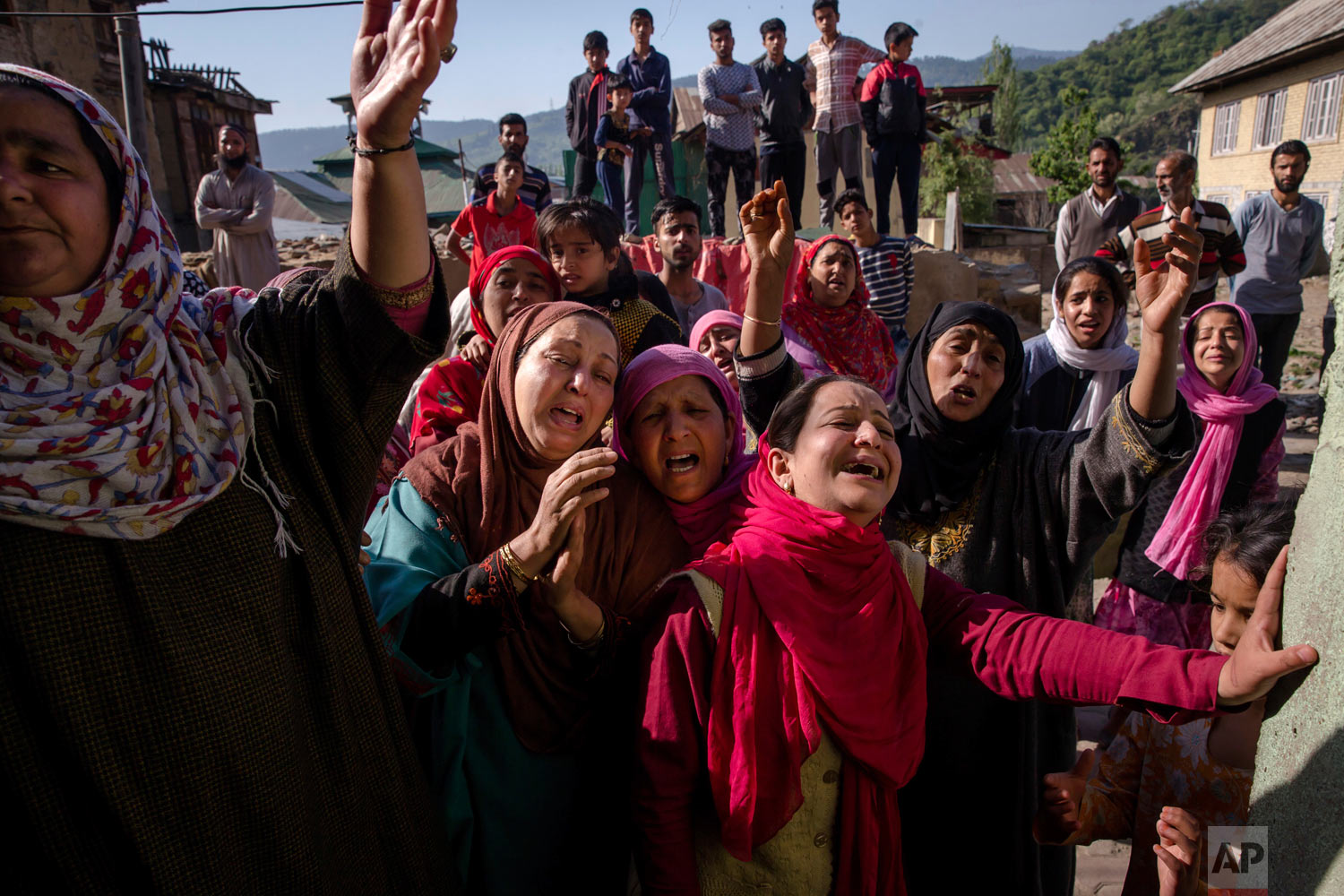 Mourners for Mohammad Asgar, one among three civilians killed, wail during his funeral in Baramulla, 60 kilometers (37 miles) west of Srinagar, Indian controlled Kashmir, Tuesday, May 1, 2018. Suspected militants shot and killed three men in Indian-