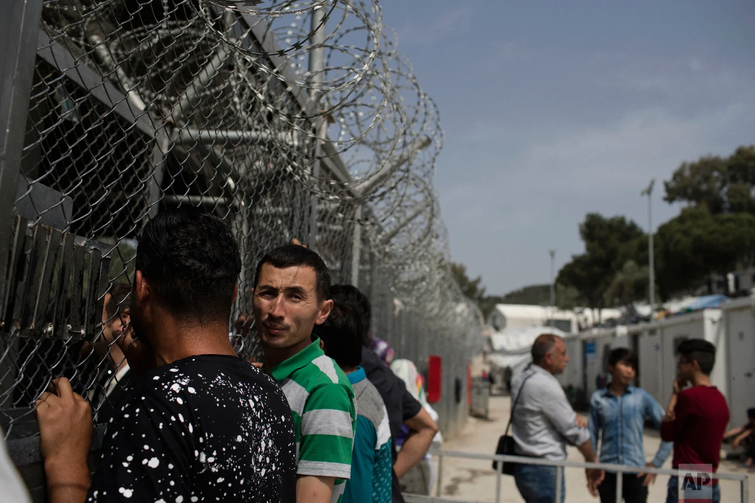 Migrants and refugees wait outside the European Asylum Support Service offices inside the camp of Moria on the northeastern Aegean island of Lesbos, Greece on Friday, May 4, 2018. (AP Photo/Petros Giannakouris)