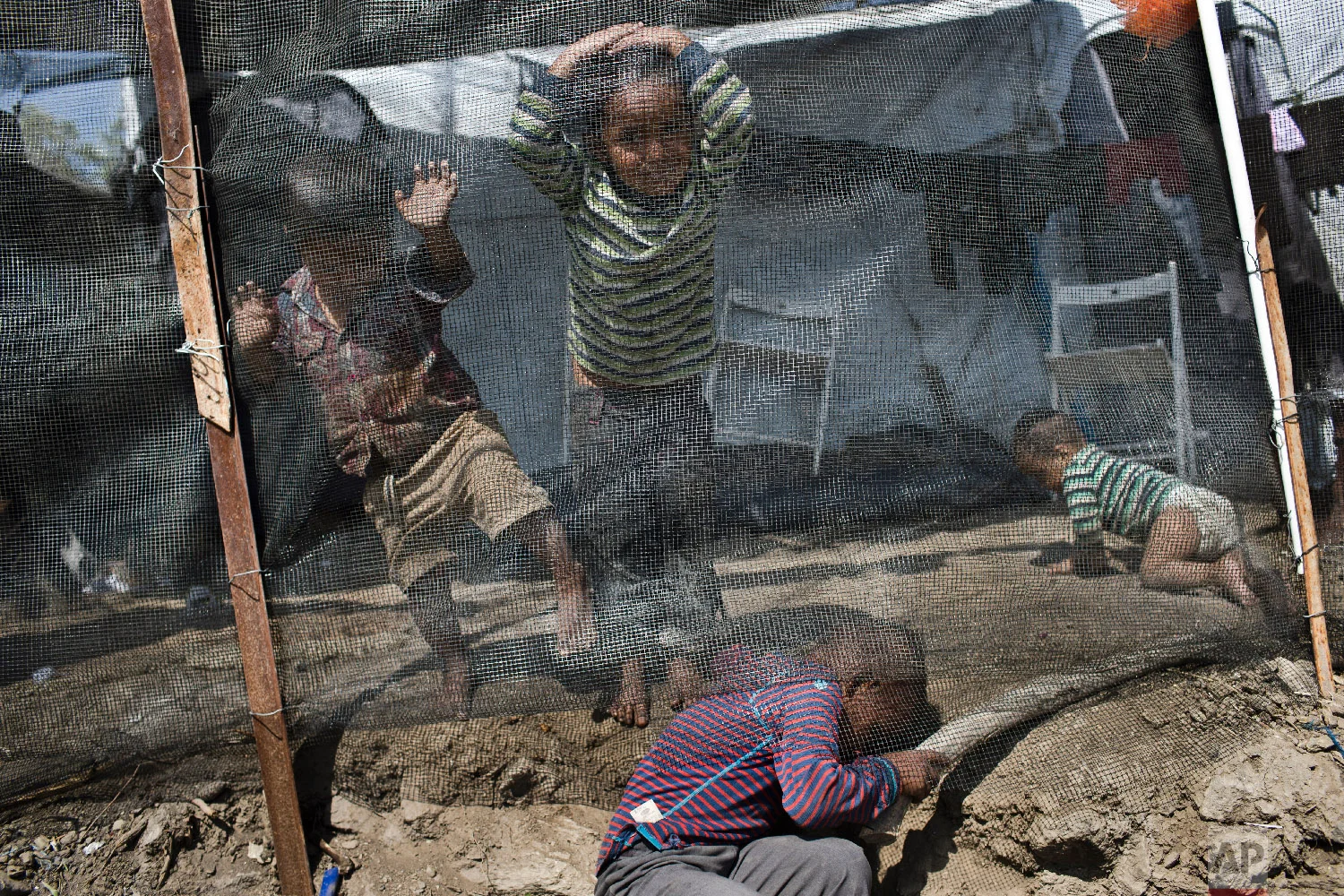 Syrian children play outside their family tent at a makeshift camp outside Moria on the northeastern Aegean island of Lesbos, Greece on Tuesday, May 2, 2018. (AP Photo/Petros Giannakouris)