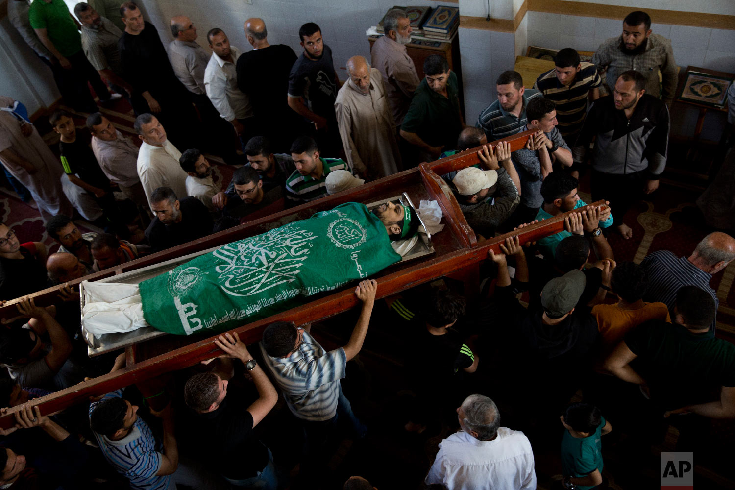 Palestinians carry the body of Mousab Abu Leila, 29, during his funeral after he was killed during a protest on the border with Israel, in Gaza City, Monday, May 14, 2018. (AP Photo/Dusan Vranic)
