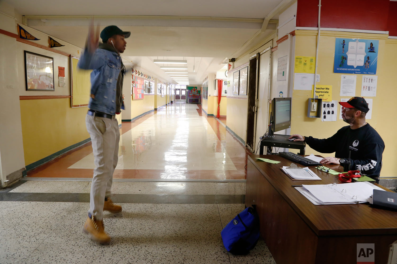  Gerald Smith, student advocate and dean of restorative justice at Chicago's North Lawndale College Prep High School, right, watches after telling a student to do jumping jacks as a consequence for arriving late to school on Thursday, April 19, 2018.