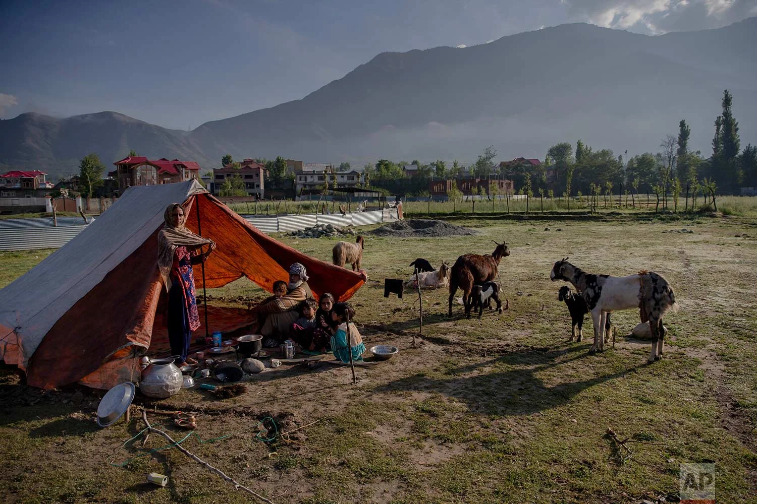 In this May 9, 2018, photo, a Kashmiri nomadic Bakarwal family camps in outskirts of Srinagar, Indian controlled Kashmir. (AP Photo/Dar Yasin)