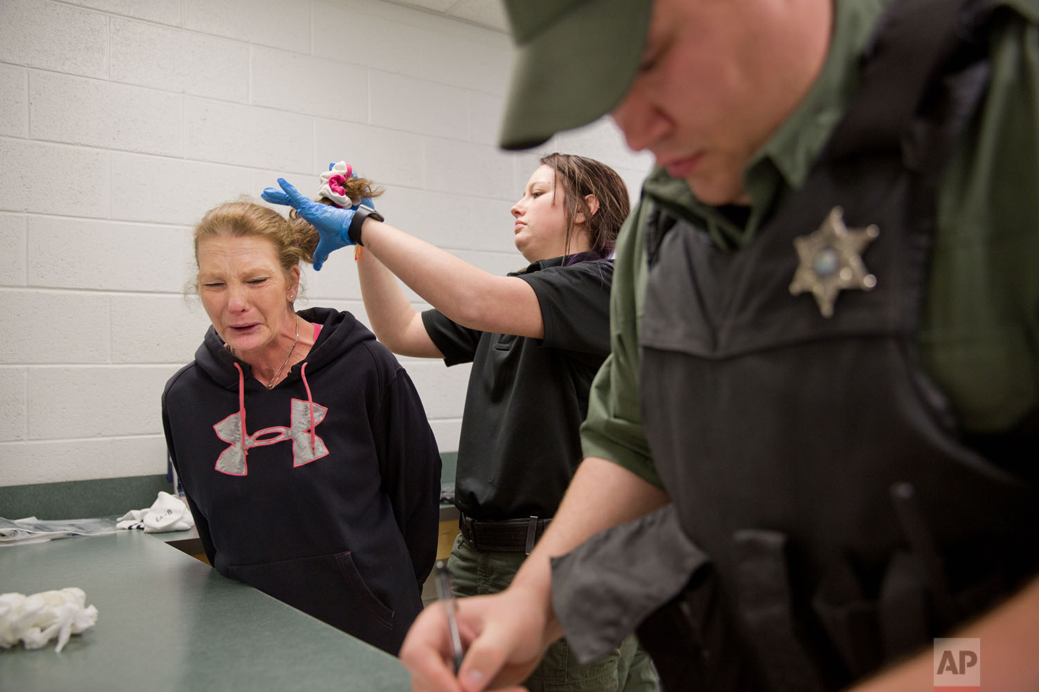  Linda Green, 51, who has struggled with drug addiction, cries as she's booked into the Campbell County Jail after being arrested on charges of public intoxication, a parole violation, in Jacksboro, Tenn., Thursday, March 29, 2018. (AP Photo/David Go