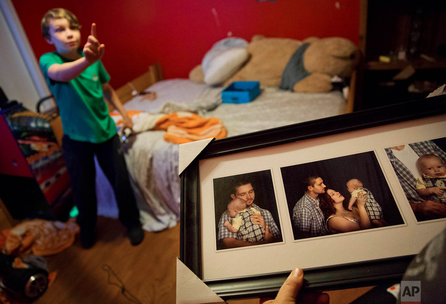  Eddy Sweat, looks at baby photos of his grandson Robby Wilson, who is standing on the left, in Jacksboro, Tenn., Monday, April 23, 2018. The absence of his mother, Krystle Sweat, has taken its toll on Robby, says his grandmother, Cathy Sweat. "Even 