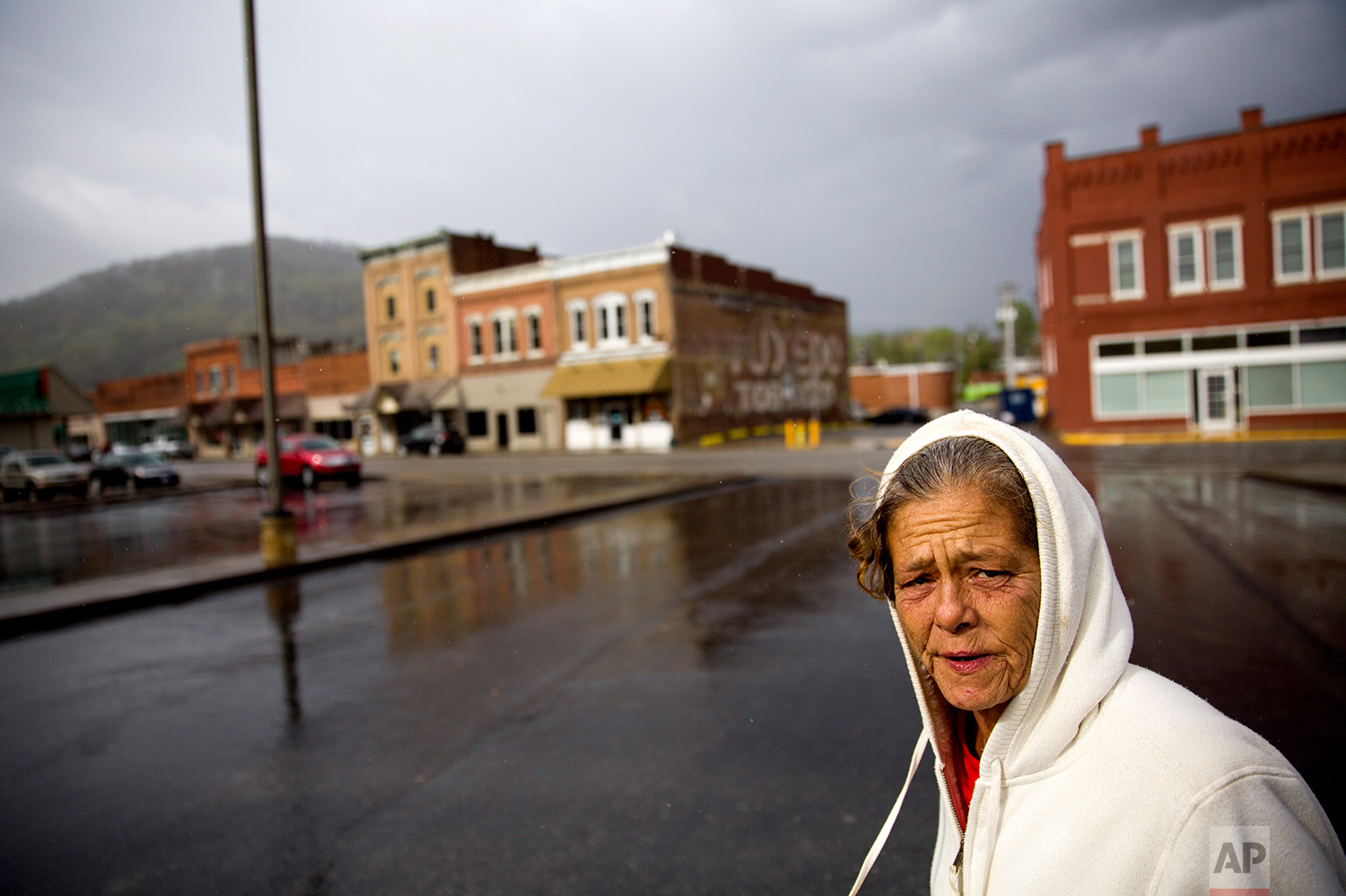  Tammy Perry, 53, walks down a street in LaFollette, Tenn., where she is currently staying with an older man after getting out of jail, Monday, April 23, 2018. Perry still struggles with drug addiction and says she exchanges sex for drugs or money to