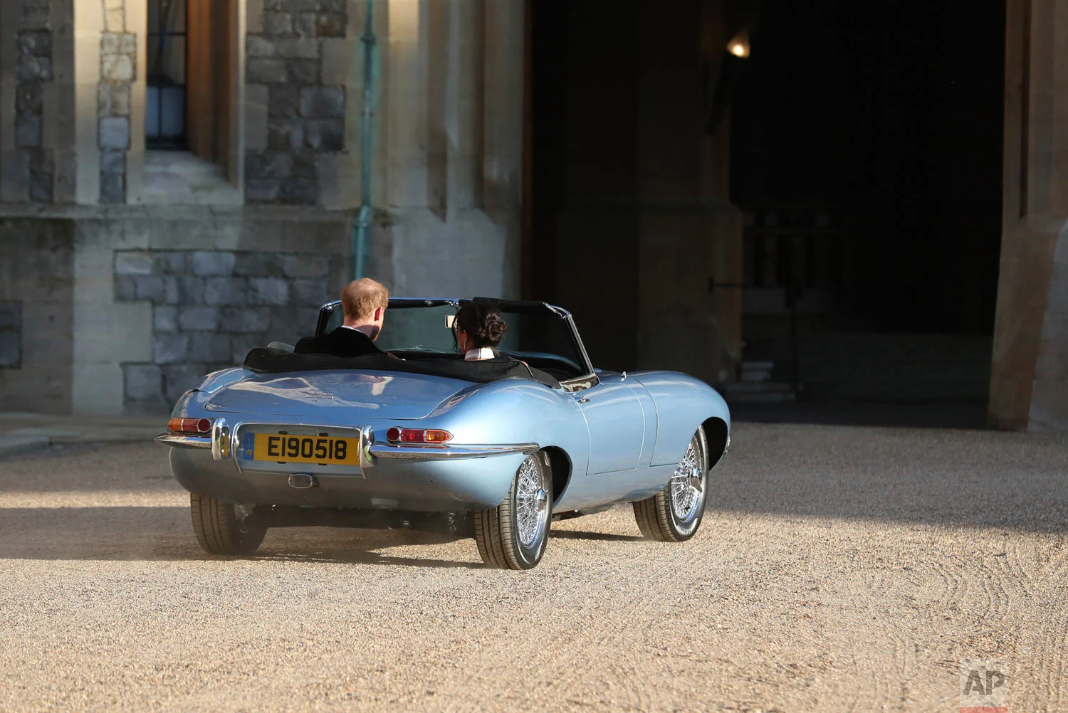 The newly married Duke and Duchess of Sussex, Meghan Markle and Prince Harry, leave Windsor Castle in a convertible car after their wedding in Windsor, England, to attend an evening reception at Frogmore House, hosted by the Prince of Wales, Saturda