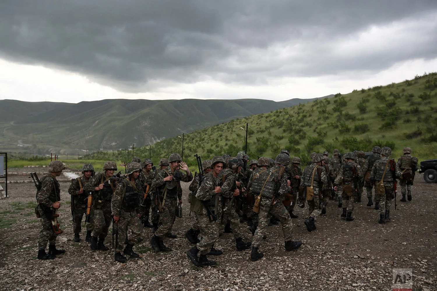 In this Friday, May 11, 2018, soldiers leave a military area after a shooting practice at Mataghis army base. (AP Photo/Thanassis Stavrakis)