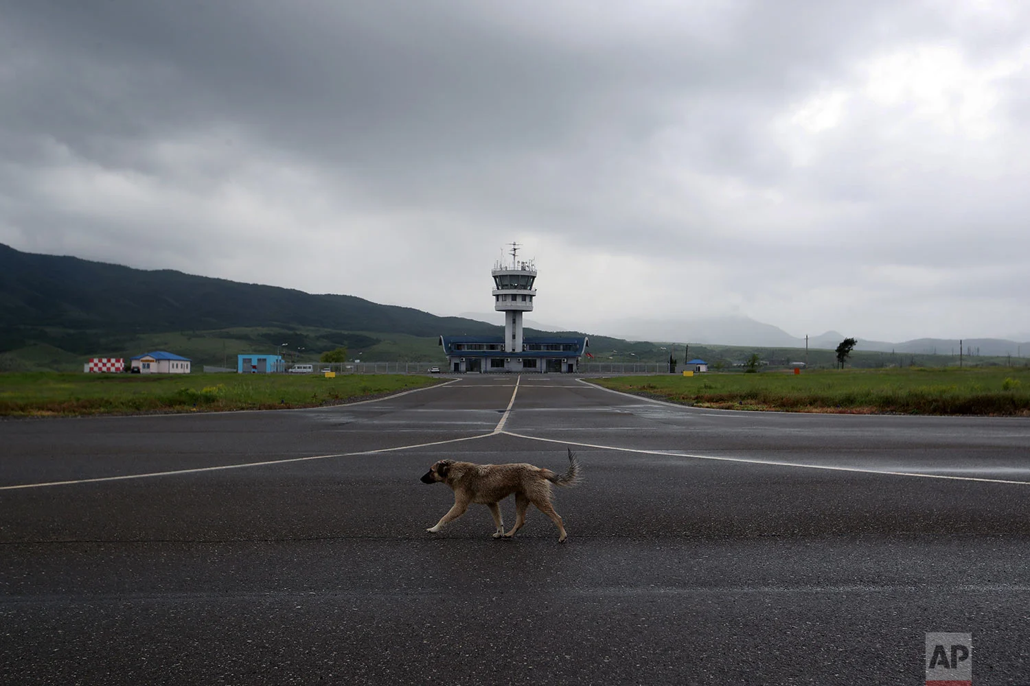 In this Friday, May 11, 2018, a dog walks on the empty runway of Stepanakert airport. (AP Photo/Thanassis Stavrakis)
