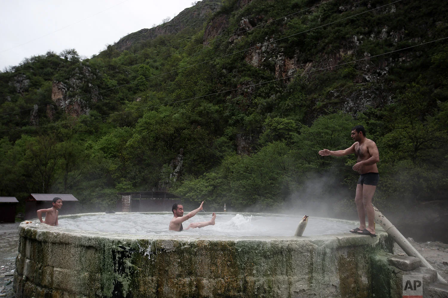 In this Saturday, May 12, 2018, local residents enjoy thermal springs in Karvachar. (AP Photo/Thanassis Stavrakis)
