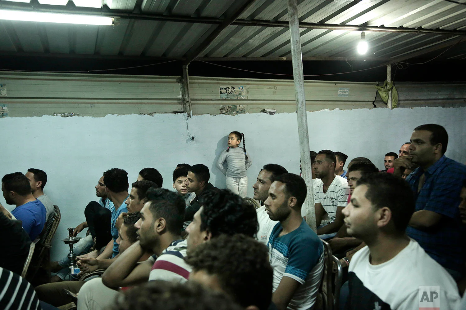 A crowd watches the Liverpool vs. Roma match at a cafe in Mohamed Salah's hometown Nile delta village of Nagrig, Egypt, May 2, 2018. (AP Photo/Nariman El-Mofty)