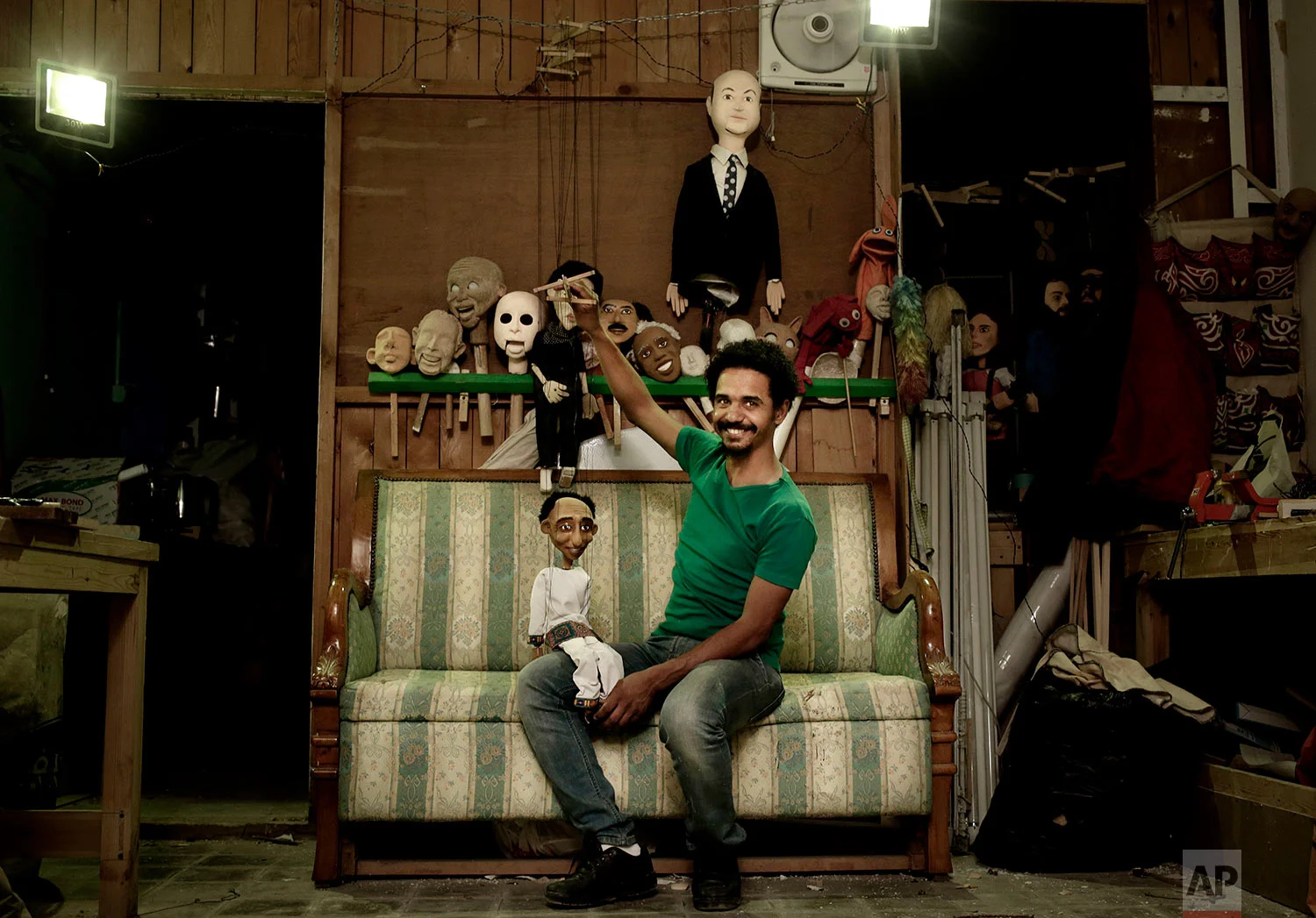 Egyptian artist Mohamed Fawzi Bakkar poses for a photograph with his favorite puppets at his workshop, in Cairo, Egypt, April 24, 2018. (AP Photo/Nariman El-Mofty)
