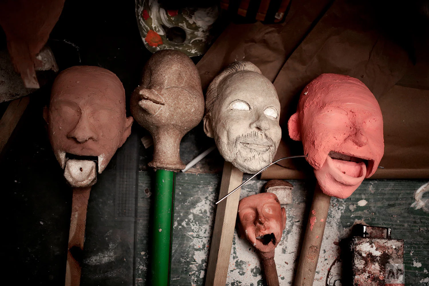 Sculptures of puppet faces made by Egyptian artist Mohamed Fawzi Bakkar, lay on a table at his workshop, in Cairo, Egypt, April 24, 2018. (AP Photo/Nariman El-Mofty)